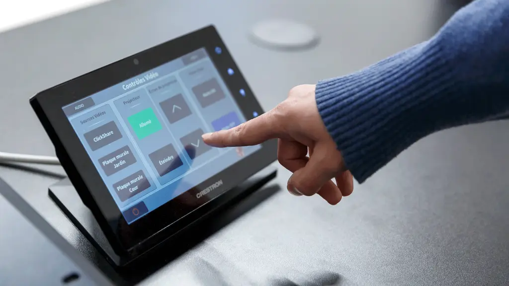woman pointing at an audiovisual control device