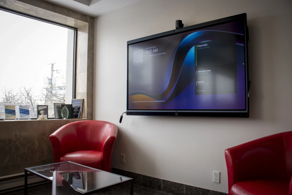 Coworking meeting room equipped with interactive screen and videoconferencing system