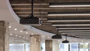 XYZ Technologies Espace Ax c close up three ceiling mounted projectors exposed concrete ceiling installation